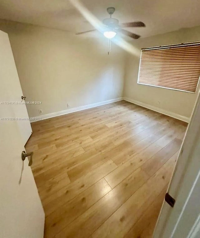 spare room with ceiling fan and light hardwood / wood-style flooring