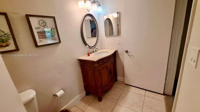 bathroom featuring tile patterned flooring, vanity, and toilet