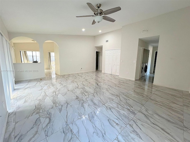 unfurnished room with washer and dryer and ceiling fan