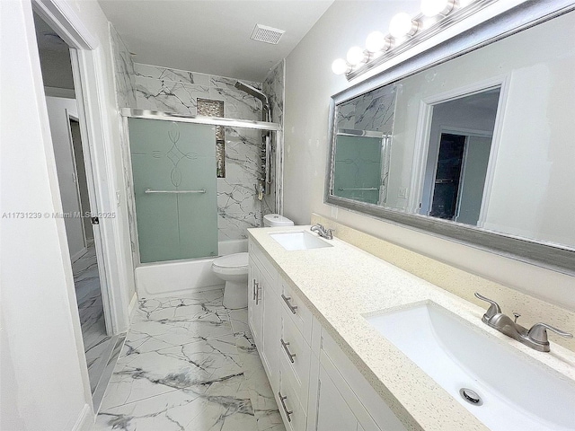 full bathroom featuring vanity, toilet, and combined bath / shower with glass door