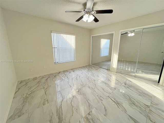 unfurnished bedroom featuring ceiling fan and a textured ceiling