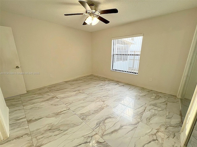 spare room with a textured ceiling and ceiling fan