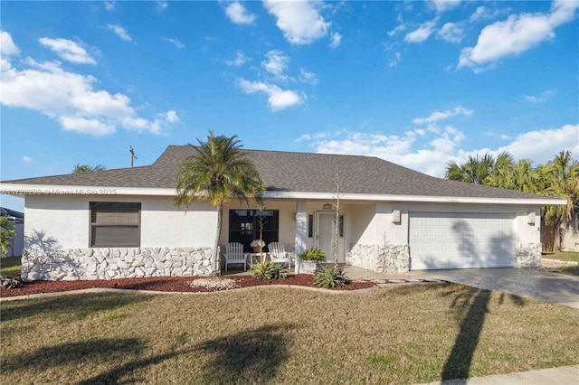 ranch-style home with a garage, a front yard, and covered porch