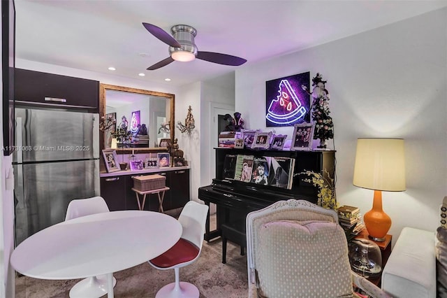 interior space featuring light colored carpet and ceiling fan