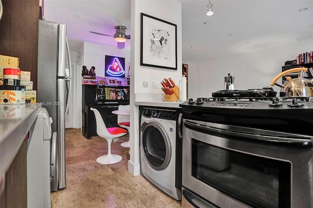 kitchen with stainless steel range with gas cooktop and washer / dryer