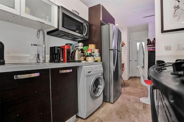 kitchen featuring white cabinetry, appliances with stainless steel finishes, washer / clothes dryer, and dark brown cabinets