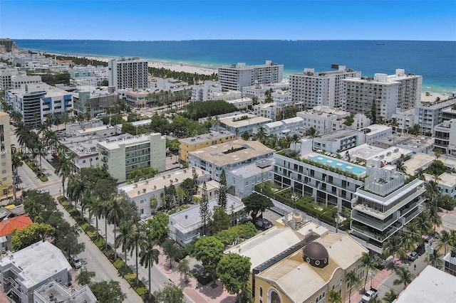 aerial view with a water view and a beach view