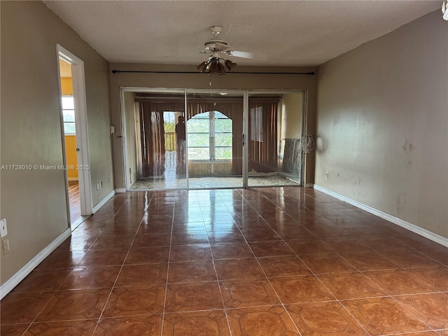 6150 NW 62nd St Unit 312, Tamarac, FL 33319 - unfurnished room featuring baseboards, tile patterned floors, and a ceiling fan
