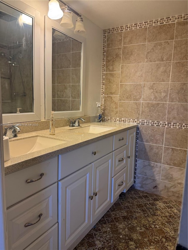 bathroom with vanity and tile walls