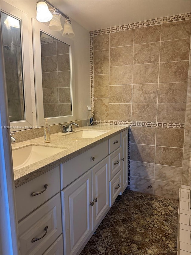 bathroom featuring vanity and tile walls