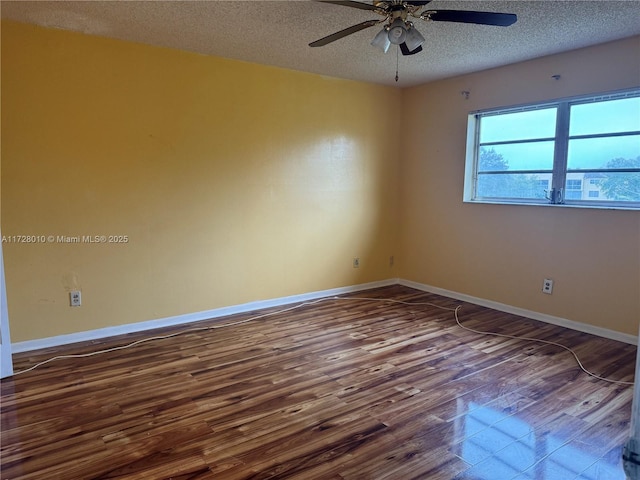 spare room with ceiling fan, wood-type flooring, and a textured ceiling