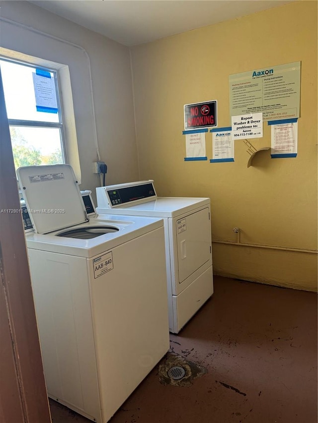 clothes washing area with washer and clothes dryer