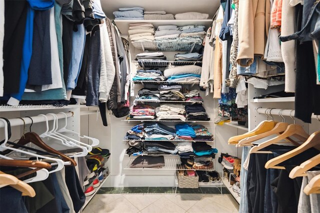 spacious closet with tile patterned floors