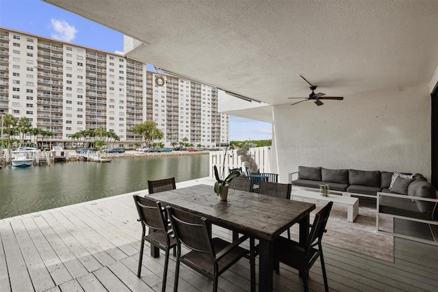 dock area with outdoor lounge area and a deck with water view