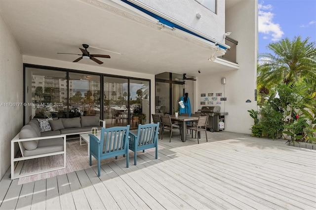 wooden terrace with area for grilling, outdoor lounge area, and ceiling fan