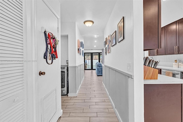 hall featuring washer / dryer and light hardwood / wood-style floors