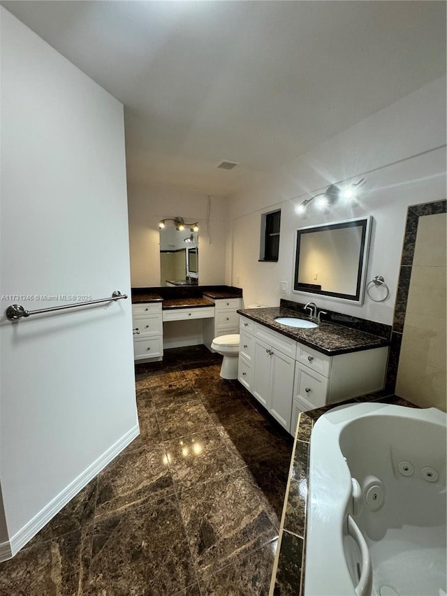 bathroom with vanity, a bath, and toilet