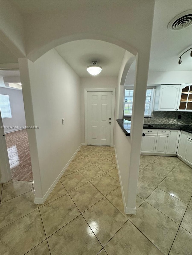 hallway featuring light tile patterned floors