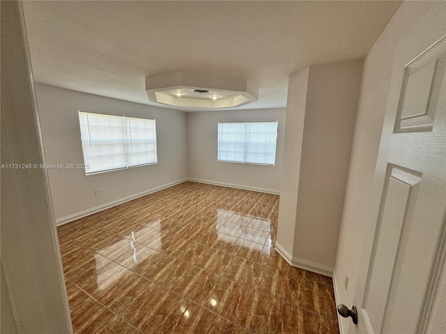 empty room with a raised ceiling