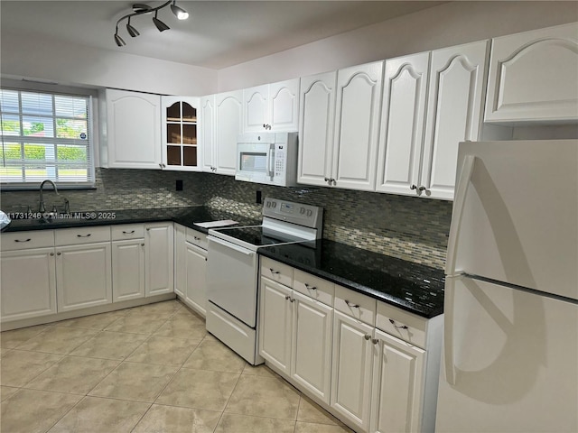 kitchen featuring white cabinetry, light tile patterned floors, white appliances, and decorative backsplash