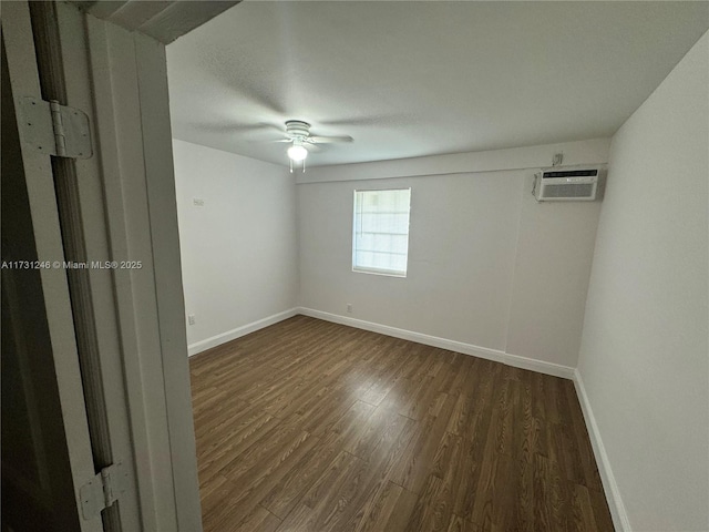 unfurnished room featuring dark hardwood / wood-style floors, a wall mounted air conditioner, and ceiling fan