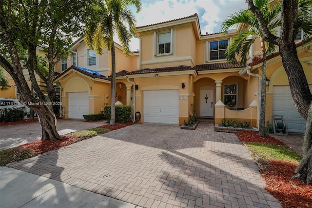 mediterranean / spanish-style home with a garage