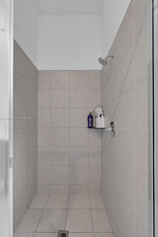 bathroom with tile patterned flooring and tiled shower