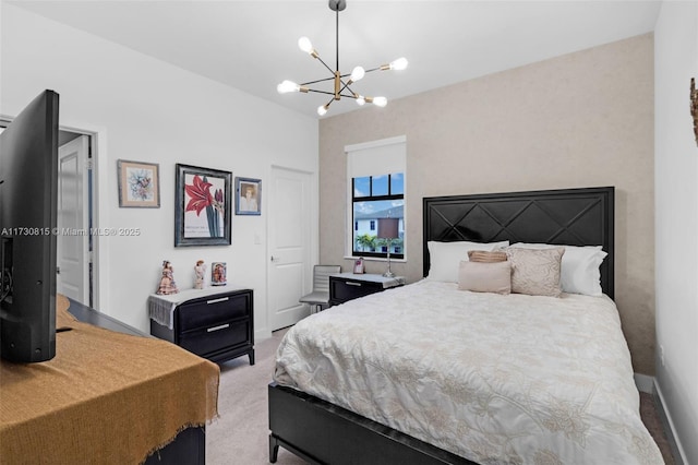 bedroom with a notable chandelier and light colored carpet