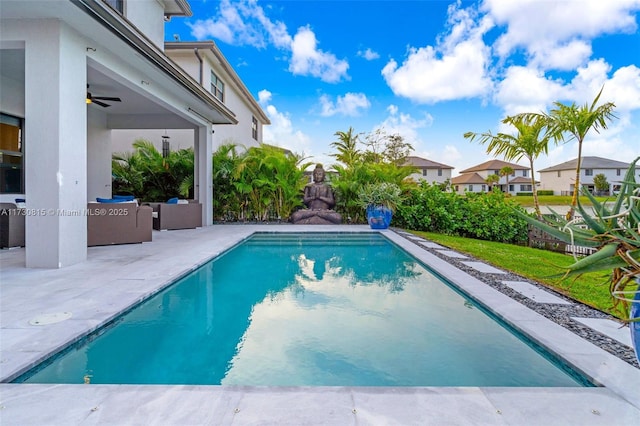 view of pool with outdoor lounge area, ceiling fan, and a patio area