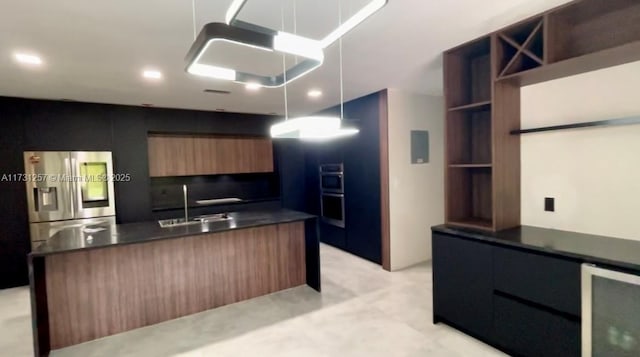 kitchen with wine cooler, sink, decorative light fixtures, and appliances with stainless steel finishes