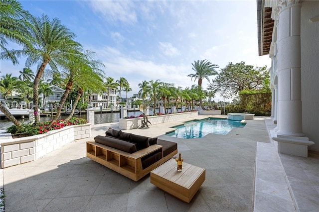 view of swimming pool featuring a patio and a water view