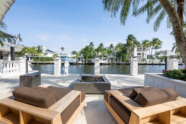 view of dock featuring a water view and a fire pit