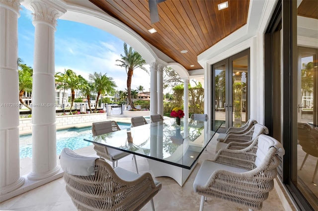 exterior space featuring wooden ceiling, decorative columns, and french doors