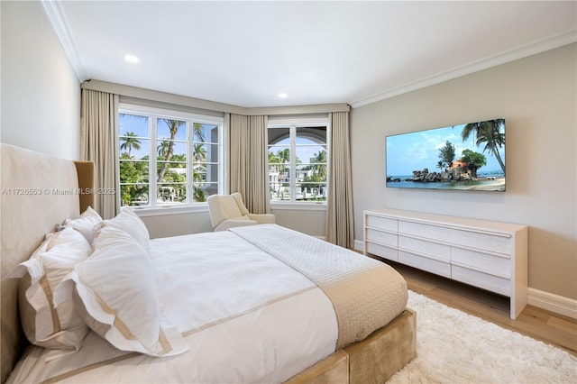 bedroom featuring crown molding and hardwood / wood-style flooring