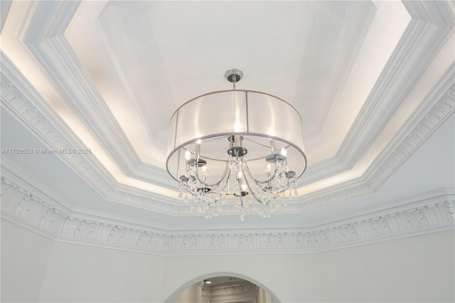 room details featuring crown molding, a notable chandelier, and a tray ceiling