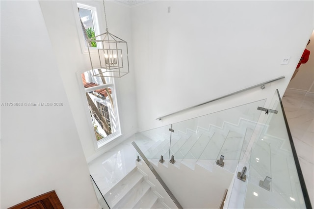 staircase featuring a chandelier