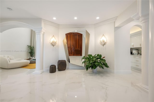 hall with crown molding and ornate columns