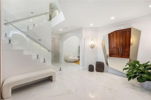 stairs featuring ornamental molding and decorative columns