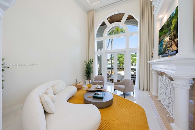 living room featuring a towering ceiling and french doors