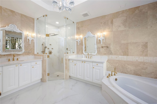 bathroom featuring vanity, independent shower and bath, and tile walls