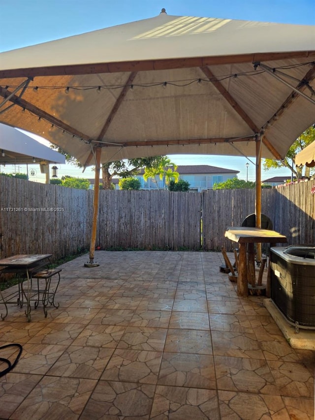 view of patio / terrace with a gazebo and cooling unit