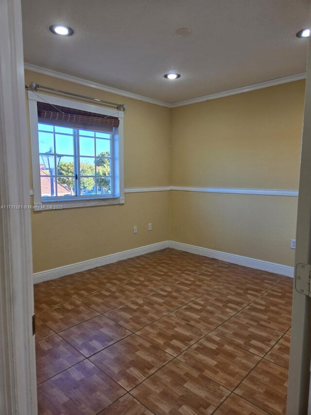 tiled empty room with crown molding