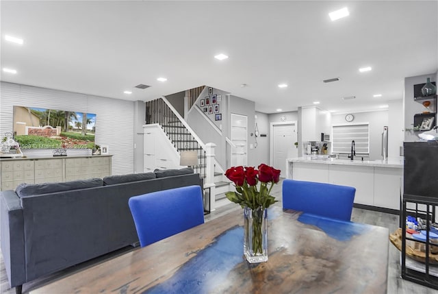 dining room with sink and light hardwood / wood-style flooring