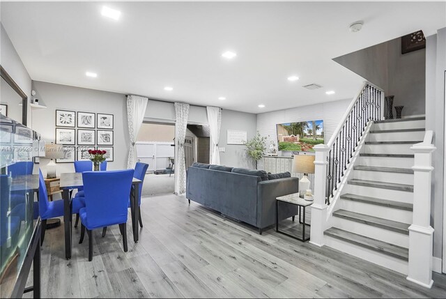 dining area featuring sink and light hardwood / wood-style floors