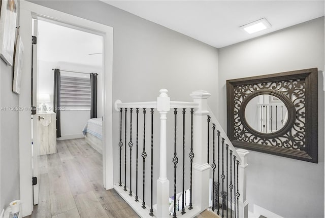 staircase with hardwood / wood-style floors