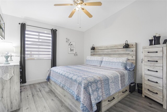 bedroom with lofted ceiling, hardwood / wood-style floors, and ceiling fan