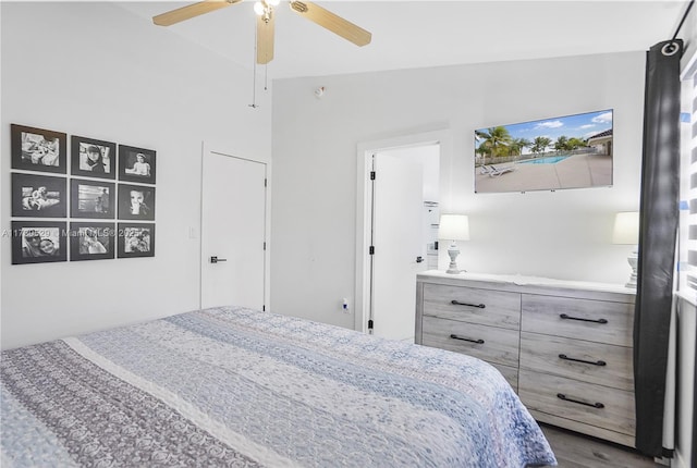 bedroom with lofted ceiling, hardwood / wood-style floors, and ceiling fan