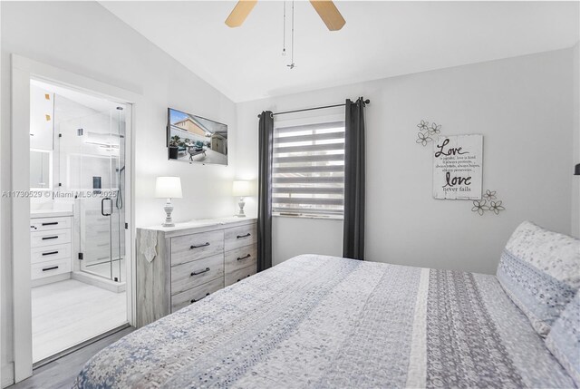 bedroom featuring lofted ceiling, connected bathroom, wood-type flooring, and ceiling fan