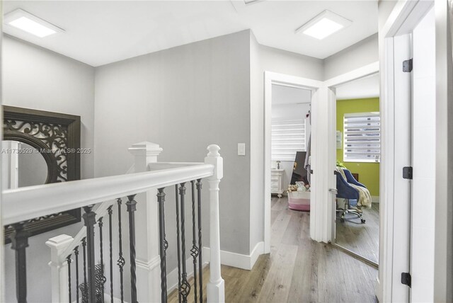 corridor with light hardwood / wood-style flooring