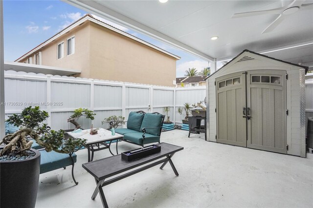 view of patio with a storage shed and outdoor lounge area